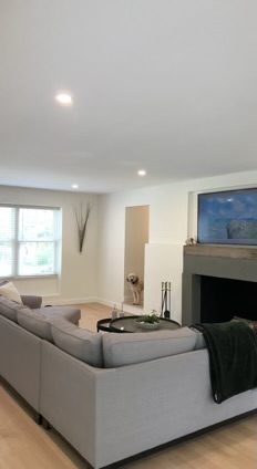 Modern, updated family room with recessed lighting, frame television, and smart lighting controls.